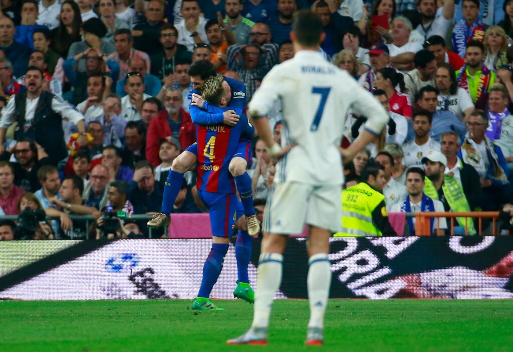 671997186 MADRID, SPAIN - APRIL 23: Ivan Rakitic of Barcelona (4) celebrates as he scores their second goal with Lionel Messi of Barcelona as Cristiano Ronaldo of Real Madrid looks dejected during the La Liga match between Real Madrid CF and FC Barcelona at Estadio Bernabeu on April 23, 2017 in Madrid, Spain. (Photo by Gonzalo Arroyo Moreno/Getty Images)