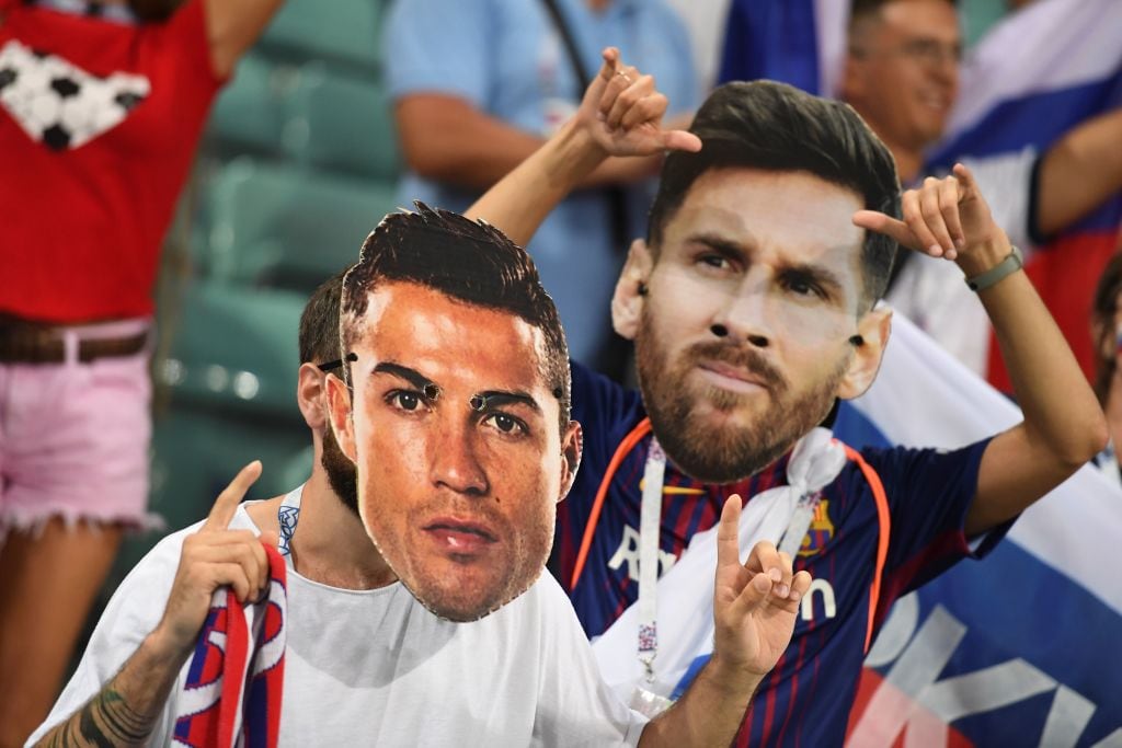 993427428 Football fans wearing masks depicting Portugal's forward Cristiano Ronaldo and Argentina's forward Lionel Messi pose before the Russia 2018 World Cup quarter-final football match between Russia and Croatia at the Fisht Stadium in Sochi on July 7, 2018. (Photo by Kirill KUDRYAVTSEV / AFP) / RESTRICTED TO EDITORIAL USE - NO MOBILE PUSH ALERTS/DOWNLOADS (Photo credit should read KIRILL KUDRYAVTSEV/AFP via Getty Images)