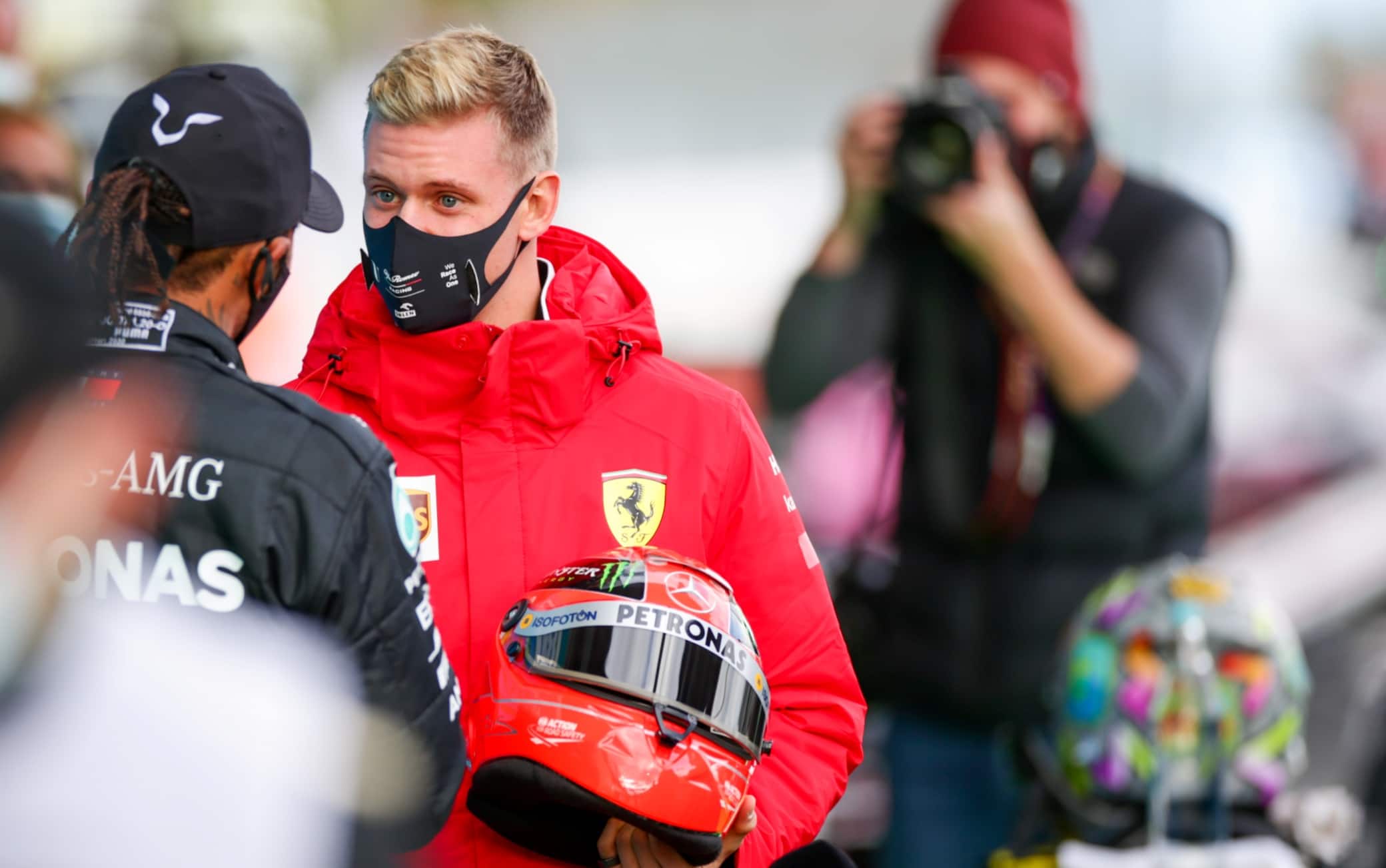 NUERBURG, GERMANY - OCTOBER 11: Mick Schumacher of Germany and Ferrari presents Lewis Hamilton of Mercedes and Great Britain  with his father Michael Schumacher's helmet to celebrate equalling his father's achievement of 91 wins during the F1 Eifel Grand Prix at Nuerburgring on October 11, 2020 in Nuerburg, Germany. (Photo by Peter Fox/Getty Images)