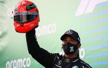 Winner Mercedes' British driver Lewis Hamilton celebrates on the podium after the German Formula One Eifel Grand Prix at the Nuerburgring circuit in Nuerburg, western Germany, on October 11, 2020. (Photo by Bryn Lennon / POOL / AFP) (Photo by BRYN LENNON/POOL/AFP via Getty Images)