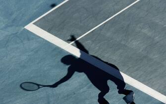 ATHENS - AUGUST 16:  (THIS PHOTO HAS BEEN ROTATED 180 DEGREES FOR AESTHETIC PURPOSES) The shadow of Amelie Mauresmo of France is seen on the court as she serves to Conchita Martinez of Spain during their women's singles tennis match on August 16, 2004 during the Athens 2004 Summer Olympic Games at the Olympic Sports Complex Tennis Centre in Athens, Greece. (Photo by Robert Laberge/Getty Images)