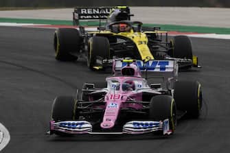 epa08772737 Canadian Formula One driver Lance Stroll of BWT Racing Point (front) and French Formula One driver Esteban Ocon of Renault (back) in action during the 2020 Formula One Grand Prix of Portugal at the Autodromo Internacional do Algarve near Portimao, Portugal, 25 October 2020.  EPA/Rudy Carezzevoli / Pool