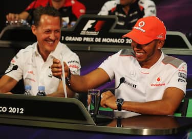 MONTE CARLO, MONACO - MAY 23:  Lewis Hamilton (R) of Great Britain and McLaren talks with Michael Schumacher (L) of Germany and Mercedes GP at the drivers press conference during previews to the Monaco Formula One Grand Prix at the Monte Carlo Circuit on May 23, 2012 in Monte Carlo, Monaco.  (Photo by Clive Mason/Getty Images)