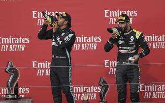 epa08790945 Winner British Formula One driver Lewis Hamilton of Mercedes-AMG Petronas (L) and third Australian Formula One driver Daniel Ricciardo of Renault (R) drink champagne from their shoes after the Formula One Grand Prix Emilia Romagna at Imola race track, Italy, 01 November 2020.  EPA/Luca Bruno / Pool