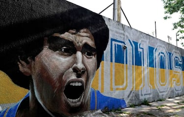 View of murals depicting Argentinian football legend Diego Maradona at La Boca neighborhood, in Buenos Aires on November 25, 2020, on the day of his death. (Photo by ALEJANDRO PAGNI / AFP) (Photo by ALEJANDRO PAGNI/AFP via Getty Images)