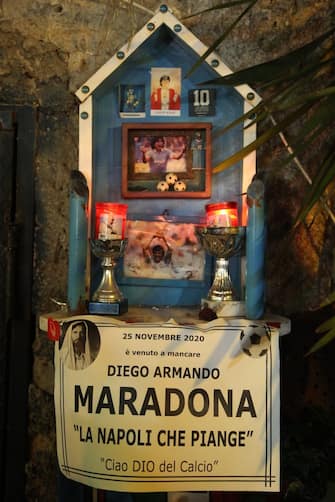 A shrine with the inscription "Maradona has passed away on November 25, 2020. Napoli is crying, Goodbye to the God of Football" at the so-called "Maradona Corner" at the top of the Quartieri Spagnoli in Naples on November 25, 2020 after the annoucement's of Argentinian football legend Diego Maradona's death. - Argentine football legend Diego Maradona has died at the age of 60, his spokesman announced November 25, 2020. (Photo by Carlo Hermann / AFP) (Photo by CARLO HERMANN/AFP via Getty Images)