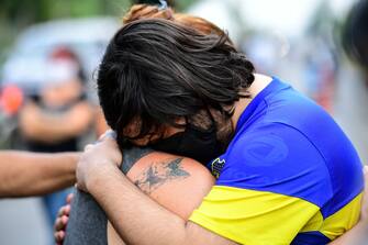 People mourn outside the gated community where Argentine football star Diego Maradona's home is located, in Benavidez, Buenos Aires province, where he died on November 25, 2020. (Photo by RONALDO SCHEMIDT / AFP) (Photo by RONALDO SCHEMIDT/AFP via Getty Images)