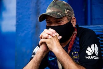 BUENOS AIRES, ARGENTINA - NOVEMBER 25: A fan cries after the news of the death of Diego Maradona was known at Boca Junior's Bombonera Stadium on November 25, 2020 in Buenos Aires, Argentina. Argentine soccer legend Diego Armando Maradona died today aged 60. (Photo by Tomas Cuesta/Getty Images)