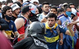 Diego Maradona's fans argue with police to enter the Government House to pay tribute to late football legend Diego Armando Maradona in Buenos Aires, on November 26, 2020. - Diego Maradona's coffin arrived at the presidential palace in Buenos Aires for a period of lying in state, TV reports showed, following the death of the Argentine football legend aged 60 on November 25. Hundreds of people were already lining up to pay their respects to Maradona, who died while recovering from a brain operation, the images from sports channels TyC and ESPN showed. (Photo by ALEJANDRO PAGNI / AFP) (Photo by ALEJANDRO PAGNI/AFP via Getty Images)