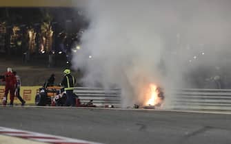 epa08850770 Flames on the crash site of French Formula One driver Romain Grosjean of the Haas F1 Team during the start of the Formula One Grand of Bahrain on the Bahrain International Circuit in Sakhir, Bahrain, 29 November 2020.  EPA/TOLGA BOZOGLU / POOL