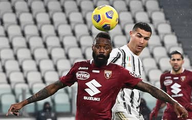 Juventus' Portuguese forward Cristiano Ronaldo (R) fights for the ball with Torino's Cameroon defender Nicolas Nkoulou during the Italian Serie A football match Juventus vs Torino on December 5, 2020 at Allianz Stadium in Turin. (Photo by Andreas SOLARO / AFP) (Photo by ANDREAS SOLARO/AFP via Getty Images)