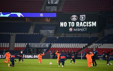 Football players and referees kneel on the pitch against racism before the UEFA Champions League group H football match between Paris Saint-Germain (PSG) and Istanbul Basaksehir FK at the Parc des Princes stadium in Paris, on December 9, 2020. (Photo by FRANCK FIFE / AFP) (Photo by FRANCK FIFE/AFP via Getty Images)