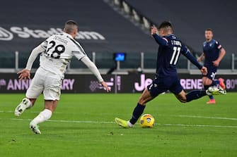 Lazio's Argentine forward Joaquin Correa (R) kicks the ball and scores his team's first goal during the Italian Serie A football match between Juventus and Lazio at The Juventus Stadium in Turin, northern Italy on March 6, 2021. (Photo by MIGUEL MEDINA / AFP) (Photo by MIGUEL MEDINA/AFP via Getty Images)