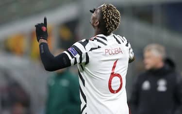 MILAN, ITALY - MARCH 18: Paul Pogba of Manchester United celebrates after scoring to give the side a 1-0 lead during the UEFA Europa League Round of 16 Second Leg match between AC Milan and Manchester United at San Siro on March 18, 2021 in Milan, Italy. Sporting stadiums around Europe remain under strict restrictions due to the Coronavirus Pandemic as Government social distancing laws prohibit fans inside venues resulting in games being played behind closed doors. (Photo by Jonathan Moscrop/Getty Images)