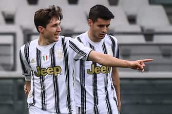 Juventus' Italian forward Federico Chiesa (L) celebrates with Juventus' Spanish forward Alvaro Morata after opening the scoring during the Italian Serie A football match Torino vs Juventus on April 03, 2021 at the Olympic stadium in Turin. (Photo by Marco BERTORELLO / AFP) (Photo by MARCO BERTORELLO/AFP via Getty Images)