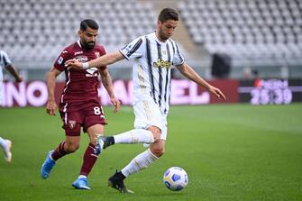 TURIN, ITALY - APRIL 03: (L-R) TomÃ¡s RincÃ³n of Torino FC against Rodrigo Bentancur of Juventus FC during the Serie A match between Torino FC and Juventus at Stadio Olimpico di Torino on April 3, 2021 in Turin, Italy. Sporting stadiums around Italy remain under strict restrictions due to the Coronavirus Pandemic as Government social distancing laws prohibit fans inside venues resulting in games being played behind closed doors. (Photo by Stefano Guidi/Getty Images)