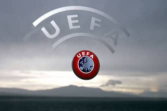 72774028 Nyon, SWITZERLAND: A UEFA logo is seen with Geneva Lake and Alps as background 08 December 2006 during a press conference closing a two days Executive committee meeting of the European football federation at the headquarters in Nyon. AFP PHOTO / FABRICE COFFRINI (Photo credit should read FABRICE COFFRINI/AFP via Getty Images)
