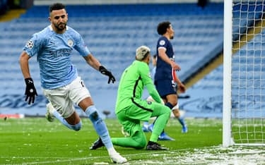 epa09177827 Manchester City's Riyad Mahrez (L) celebrates after scoring the 1-0 lead during the UEFA Champions League semi final, second leg soccer match between Manchester City and Paris Saint-Germain in Manchester, Britain, 04 May 2021.  EPA/PETER POWELL