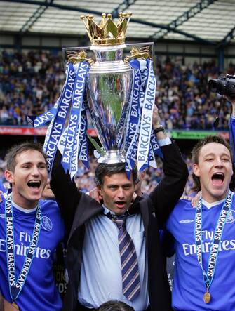 LONDON, UNITED KINGDOM:  Chelsea's Manager Jose Mourinho (C) holds aloft the Barclays Premiership trophy beside Frank Lampard (L) and John Terry (R) during the celebrations after the game against Charlton at Stamford Bridge in London 07 May 2005. AFP PHOTO Adrian DENNIS No telcos, website uses subject to subscription of a license with FAPL on www.faplweb.com <http://www.faplweb.com>  (Photo credit should read ADRIAN DENNIS/AFP via Getty Images)