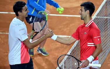 Lorenzo Sonego (L) of Italy and Novak Djokovic of Serbia after their men's singles semi final match at the Italian Open tennis tournament in Rome, Italy, 15 May 2021.  ANSA/ETTORE FERRARI
 