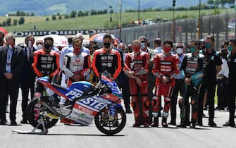 MotoGp riders and teams line up for one minute of silence in memory of the Moto 3 class rider Jason Dupasquier who died in the accident during qualifying during the Motorcycling Grand Prix of Italy at the Mugello circuit in Scarperia, central Italy, 30 May 2021. ANSA/CLAUDIO GIOVANNINI