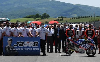 MotoGp riders and teams line up for one minute of silence in memory of the Moto 3 class rider Jason Dupasquier who died in the accident during qualifying during the Motorcycling Grand Prix of Italy at the Mugello circuit in Scarperia, central Italy, 30 May 2021. ANSA/CLAUDIO GIOVANNINI