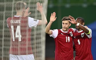 epa09103810 Christoph Baumgartner (C) of Austria celebrates with teammate David Alaba (R) and Sasa Kalajdzic after scoring during the FIFA World Cup 2022 qualifying soccer match between Austria and the Faroe Islands in Vienna, Austria, 28 March 2021.  EPA/CHRISTIAN BRUNA