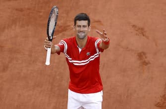 epa09268128 Novak Djokovic of Serbia celebrates winning against Stefanos Tsitsipas of Greece during their final match at the French Open tennis tournament at Roland Garros in Paris, France, 13 June 2021.  EPA/IAN LANGSDON