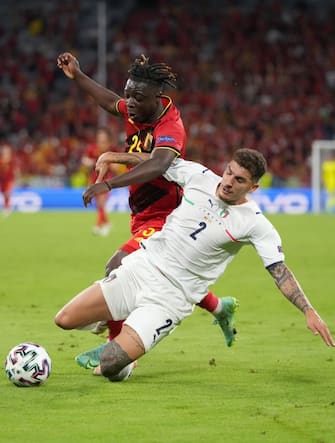 epa09319233 Jeremy Doku of Belgium in action against Giovanni Di Lorenzo of Italy (R) during the UEFA EURO 2020 quarter final match between Belgium and Italy in Munich, Germany, 02 July 2021.  EPA/Matthias Schrader / POOL (RESTRICTIONS: For editorial news reporting purposes only. Images must appear as still images and must not emulate match action video footage. Photographs published in online publications shall have an interval of at least 20 seconds between the posting.)
