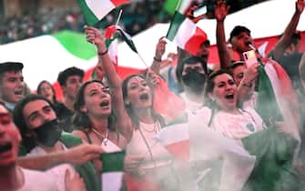 Supporters of Italy's national football team react as they look at the UEFA EURO 2020 semi-final football match between Italy and Spain, displayed on a giant screen, at the Piazza del Popolo, in Rome, on July 6, 2021. (Photo by Andreas SOLARO / AFP) (Photo by ANDREAS SOLARO/AFP via Getty Images)