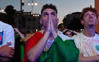 Supporters of Italy's national football team react as they look at the UEFA EURO 2020 semi-final football match between Italy and Spain, displayed on a giant screen, at the Piazza del Popolo, in Rome, on July 6, 2021. (Photo by Andreas SOLARO / AFP) (Photo by ANDREAS SOLARO/AFP via Getty Images)