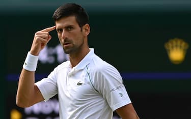 epa09337554 Novak Djokovic of Serbia reacts during the men's final against Matteo Berrettini of Italy at the Wimbledon Championships, Wimbledon, Britain 11 July 2021.  EPA/NEIL HALL   EDITORIAL USE ONLY