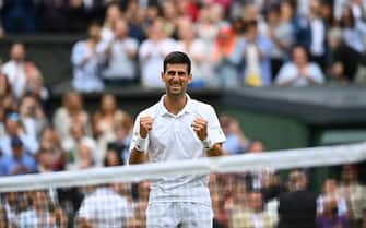 epa09337719 Novak Djokovic of Serbia celebrates after winning the men's final against Matteo Berrettini of Italy at the Wimbledon Championships, Wimbledon, Britain 11 July 2021.  EPA/NEIL HALL   EDITORIAL USE ONLY