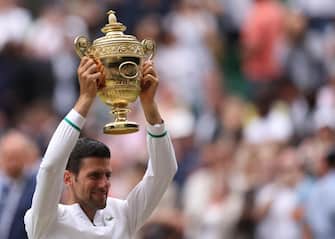 epa09337802 Novak Djokovic of Serbia poses for a photo with the trophy after winning the men's final against Matteo Berrettini of Italy at the Wimbledon Championships, Wimbledon, Britain 11 July 2021.  EPA/STEVE PASTON / POOL   EDITORIAL USE ONLY