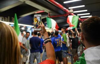 Italian fans celebrate outside the Fiumicino airport