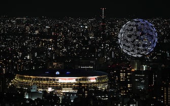 epa09359926 Picture taken from the Shibuya Sky observation deck shows drones forming a globe above the stadium during the Opening Ceremony of the Tokyo 2020 Olympic Games at the Olympic Stadium in Tokyo, Japan, 23 July 2021.  EPA/CHRISTOPHER JUE