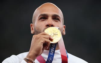 TOKYO, JAPAN - AUGUST 02: Gold medalist Lamont Marcell Jacobs of Team Italy kisses his gold medal on the podium during the medal ceremony for the Men's 100m on day ten of the Tokyo 2020 Olympic Games at Olympic Stadium on August 02, 2021 in Tokyo, Japan. (Photo by Patrick Smith/Getty Images)