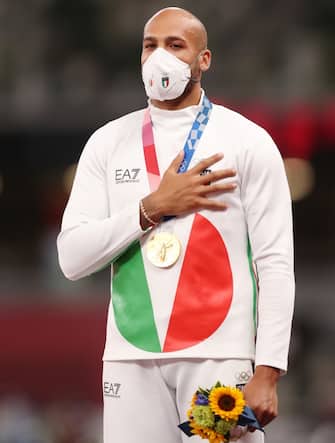 TOKYO, JAPAN - AUGUST 02: Gold medalist Lamont Marcell Jacobs of Team Italy celebrates on the podium during the medal ceremony for the Men's 100m on day ten of the Tokyo 2020 Olympic Games at Olympic Stadium on August 02, 2021 in Tokyo, Japan. (Photo by Ezra Shaw/Getty Images)