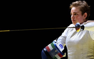 Italy's Beatrice Vio puts on her mask to compete with Russia's Ludmila Vasileva in the wheelchair fencing women's foil individual category B semi-final bout during the Tokyo 2020 Paralympic Games at Makuhari Messe Hall in Chiba on August 28, 2021. (Photo by Behrouz MEHRI / AFP) (Photo by BEHROUZ MEHRI/AFP via Getty Images)