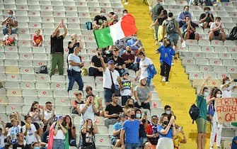 Supporters hold a flag of Italy during the FIFA World Cup Qatar 2022 qualifying round Group C football match between Italy and Bulgaria at the Artemio-Franchi stadium in Florence, on September 2, 2021. (Photo by Alberto PIZZOLI / AFP) (Photo by ALBERTO PIZZOLI/AFP via Getty Images)