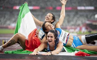 epa09447135 Ambra Sabatini, Martina Caironi and Monica Graziana Contrafatto of Italy celebrate their first three places after the Women's 100m T42 Final competition at the 2020 Tokyo Summer Paralympics Games at the Olympic Stadium in Tokyo, Japan, 04 September 2021.  EPA/ENNIO LEANZA
