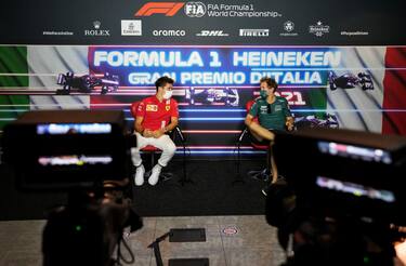 MONZA, ITALY - SEPTEMBER 09: Charles Leclerc of Monaco and Ferrari and Sebastian Vettel of Germany and Aston Martin F1 Team talk in the Drivers Press Conference during previews ahead of the F1 Grand Prix of Italy at Autodromo di Monza on September 09, 2021 in Monza, Italy. (Photo by Luca Bruno - Pool/Getty Images)