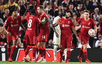 epa09470557 Mohamed Salah (2R) of Liverpool FC celebrates after scoring a goal during the UEFA Champions League group B soccer match between Liverpool FC and AC Milan in Liverpool, Britain, 15 September 2021.  EPA/Peter Powell