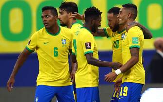 MANAUS, BRAZIL - OCTOBER 14: Raphinha of Brazil celebrates with teammates after scoring the third goal of his team during a match between Brazil and Uruguay as part of South American Qualifiers for Qatar 2022  at Arena Amazonia on October 14, 2021 in Manaus, Brazil. (Photo by Buda Mendes/Getty Images)