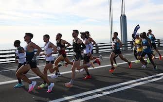 Elite men runners cross the Verrazzano-Narrows Bridge during the 2021 TCS New York City Marathon in New York on November 7, 2021. - After a forced break in 2020, the New York City Marathon is back on for its 50th edition, and with it the countless opportunities to run it for charity, an industry that has become a staple, and hopes to take off again after the pandemic. (Photo by ANGELA WEISS / AFP) (Photo by ANGELA WEISS/AFP via Getty Images)