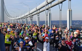 Runners cross the Verrazzano-Narrows Bridge during the 2021 TCS New York City Marathon in New York on November 7, 2021. - After a forced break in 2020, the New York City Marathon is back on for its 50th edition, and with it the countless opportunities to run it for charity, an industry that has become a staple, and hopes to take off again after the pandemic. (Photo by ANGELA  WEISS / AFP) (Photo by ANGELA  WEISS/AFP via Getty Images)
