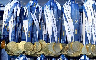 NEW YORK, NEW YORK - NOVEMBER 07: Participation medals are hung just after the finish line of the 2021 TCS New York City Marathon in Central Park on November 07, 2021 in New York City. (Photo by Elsa/Getty Images)