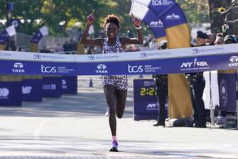 Women's division winner Peres Jepchirchir of Kenya crosses the finish line during the 2021 TCS New York City Marathon in New York on November 7, 2021. - After a forced break in 2020, the New York City Marathon is back on for its 50th edition, and with it the countless opportunities to run it for charity, an industry that has become a staple, and hopes to take off again after the pandemic. (Photo by TIMOTHY A. CLARY / AFP) (Photo by TIMOTHY A. CLARY/AFP via Getty Images)