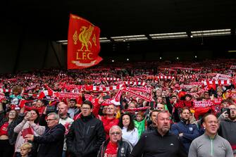 LIVERPOOL, ENGLAND - AUGUST 08: Fans of Liverpool hold up scarves as they sing Youll Never Walk Alone during the Pre-Season Friendly fixture between Liverpool and Athletic Club at Anfield on August 8, 2021 in Liverpool, England. (Photo by Robbie Jay Barratt - AMA/Getty Images)