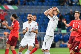 Italy's midfielder Jorginho (C) reacts after missing a penalty kick during the World Cup 2022 qualifier football match between Switzerland and Italy, on September 5, 2021 at St Jakob-Park stadium in Basel. (Photo by Fabrice COFFRINI / AFP) (Photo by FABRICE COFFRINI/AFP via Getty Images)